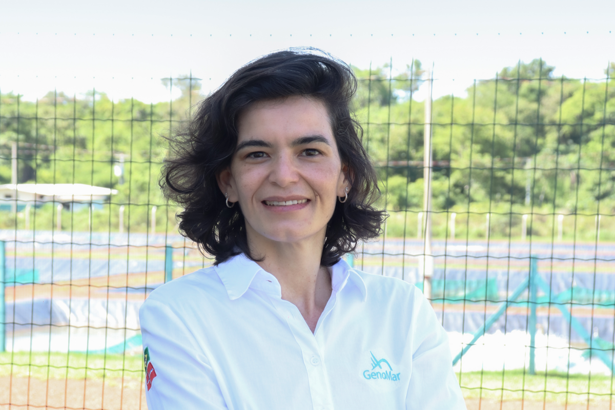 Marina Delphino stands in front of the tilapia ponds at the Breeding and Genetics Center in Brazil.